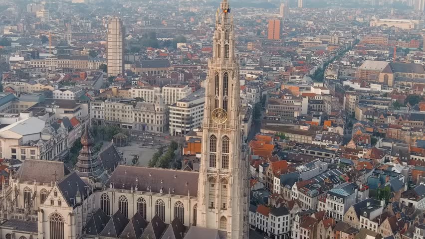 Dolly zoom. Antwerp, Belgium. Spire with the clock of the Cathedral of Our Lady (Antwerp). Historical center of Antwerp. City is located on river Scheldt (Escaut). Summer morning, Aerial View