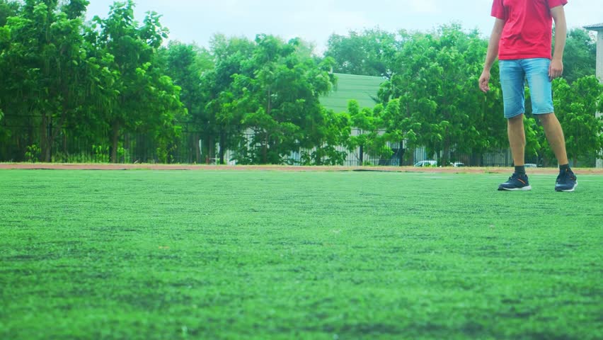 Father and daughter having fun playing soccer. Family dribbling ball together outdoors. Joyful playtime on grass in sport field, stadium. Active bonding time outside. Soccer game with ball for family 