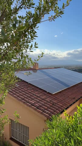 Vertical video of solar electric batteries, cell panels or PV modules is installed on house roof. Photovoltaic Solar array system for producing clean ecological electricity. Renewable energy, Europe