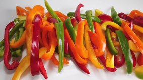 green, orange, yellow, red sweet paprika slices, motion - Powered by Shutterstock - Get 15% off with code: PIKWIZARD15