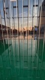 Slow upward pan from pool to glass office tower. Water mirrors the structure while building reflects pool. A mesmerizing dance of reflections showcases modern architecture's beauty in urban setting - Powered by Shutterstock - Get 15% off with code: PIKWIZARD15
