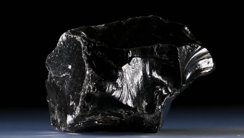 Black Obsidian (from Mexico) Natural volcanic glass, sample rotating slowly against a black background.
