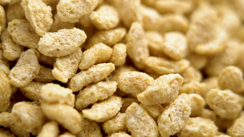 Crispy whole grain flakes with a rich texture and bold cereal flavour for organic morning breakfast. Macro. Rotation