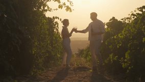 Loving couple in vineyards with wine and glasses celebrating anniversary, having romantic date. Happy woman and man dating outdoors at nature relax during grapes harvest season - Powered by Shutterstock - Get 15% off with code: PIKWIZARD15