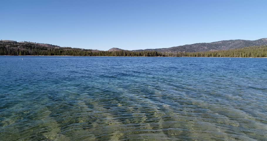 low angle drone while moving forward of redfish lake in stanley idaho