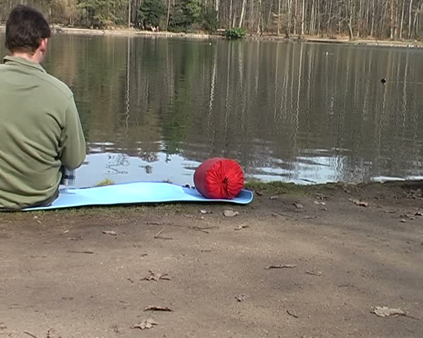 man relaxing by the lake