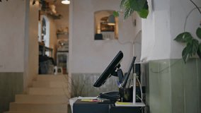 Girl working at restaurant counter focused on processing payments closeup. Female employee handling customer transactions on monitor. Woman waitress entering data in digital cash register in cafe. - Powered by Shutterstock - Get 15% off with code: PIKWIZARD15