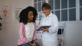 Woman breast physician discussing treatment plan with young female patient - Powered by Shutterstock - Get 15% off with code: PIKWIZARD15