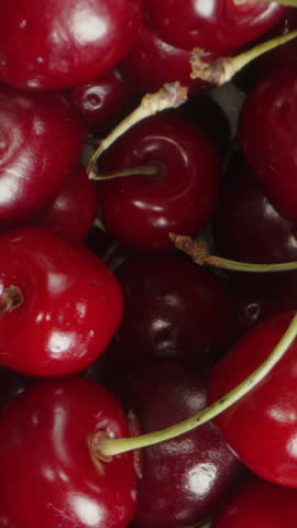 Vertical video. Close-Up Background of Cherries, Rotating and Macro Zoom, Top View.