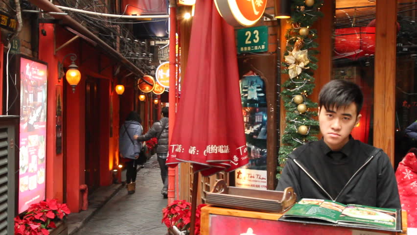 SHANGHAI - DECEMBER 21: Restaurant receptionist in Shanghai Tianzifang.