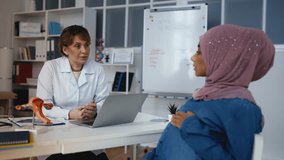 Gynecologist explaining diagnosis to worried pregnant Arab woman, sad news - Powered by Shutterstock - Get 15% off with code: PIKWIZARD15