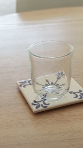Drinking water filling glass on table in modern kitchen aesthetic