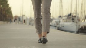 Businesswoman Walk Along Marina, Showcasing Loafers and Dress Pants. Yachts and Boats Create Picturesque Backdrop - Powered by Shutterstock - Get 15% off with code: PIKWIZARD15