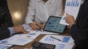 Business people collaborating in a meeting, analyzing financial documents and discussing strategies for growth and success - Powered by Shutterstock - Get 15% off with code: PIKWIZARD15