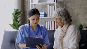 Young female doctor interviewing an elderly patient while taking notes on a clipboard during a medical consultation - Powered by Shutterstock - Get 15% off with code: PIKWIZARD15
