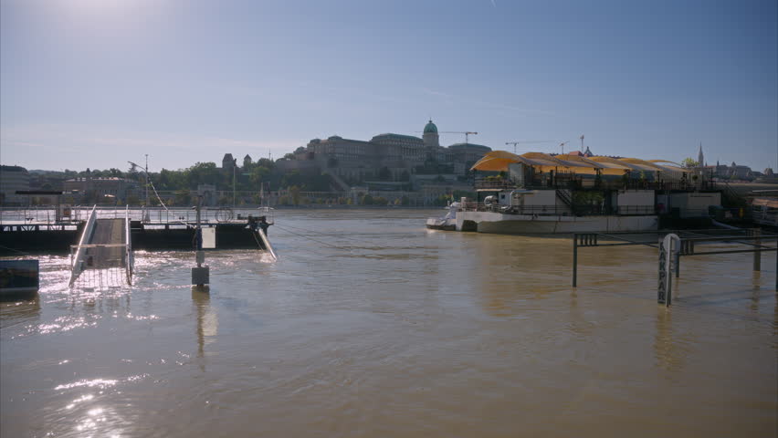 Rakpart in Budapest flooded by the Danube after excessive heavy rains in Central Europe. Floodwaters are covering roads in Hungary. View of Buda Castle during the flood. Water covering the roads.