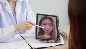 Young asian patient woman consulting with doctor in coat about wrinkle and skin for rejuvenate and beauty while watching tablet in modern medical office, doctor explaining and diagnostic facial. - Powered by Shutterstock - Get 15% off with code: PIKWIZARD15
