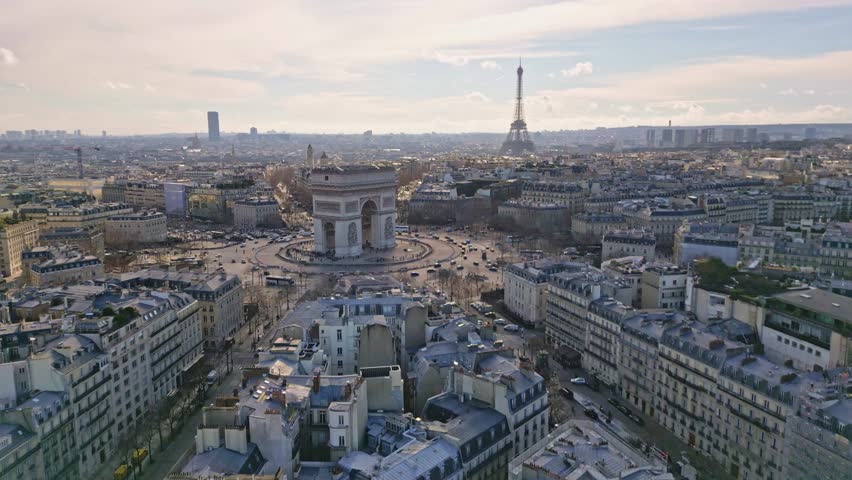 Aerial view of Triumphal Arch and Tour Eiffel, Paris in France. Aerial drone ascending forward