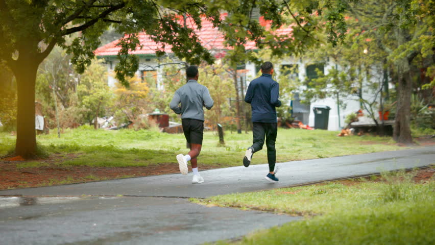 Men, running and park with marathon training, sport and athlete on job for fitness outdoor. Path, cardio and friends back with race exercise and workout for health and wellness in winter on trail