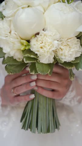 beautiful decorated wedding bouquet of white roses before the wedding ceremony. In the hotel room, the bride