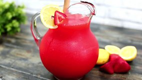Strawberry lemonade mix juice, a vibrant red delight, is poured into a beautiful glass jar. This refreshing drink combines the sweetness of strawberries with zesty lemon, perfect for any occasion - Powered by Shutterstock - Get 15% off with code: PIKWIZARD15