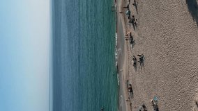 Video of people on the beach drone view.Vertical video - Powered by Shutterstock - Get 15% off with code: PIKWIZARD15