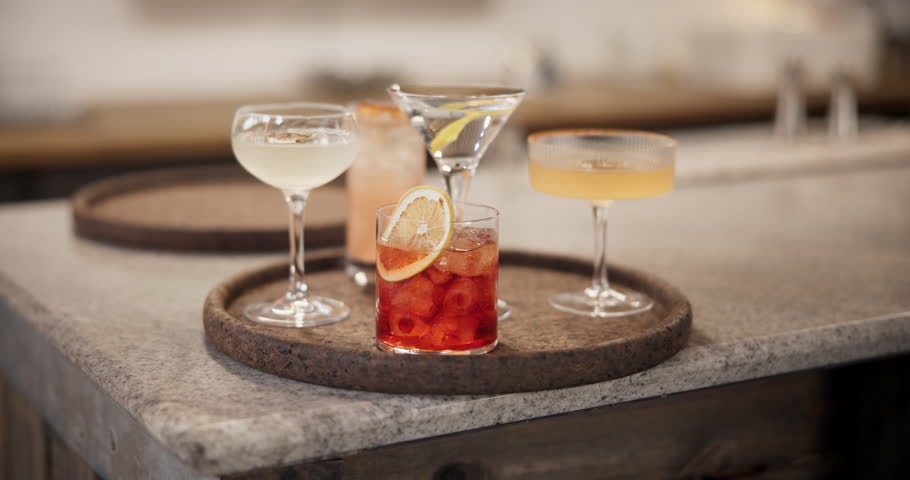 Drinks, hospitality and service on counter of bar for celebration, event or party with alcohol. Beverage, cocktail and glasses in pub or restaurant for entertainment, mixology and preparation