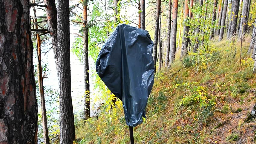 The guard removes the plastic bag from the danger warning sign.