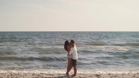 A loving couple runs towards each other, embracing and kissing on the beach in slow motion. This romantic scene captures the joy and passion of a carefree summer day by the ocean. - Powered by Shutterstock - Get 15% off with code: PIKWIZARD15