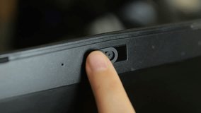 Female finger using closing webcam privacy cover slider shutter on black laptop. - Powered by Shutterstock - Get 15% off with code: PIKWIZARD15