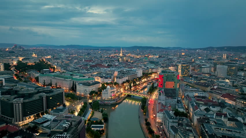 Aerial view of famous places Vienna skyline at night, Austria. Old town and new buildings at sunrise river Donau