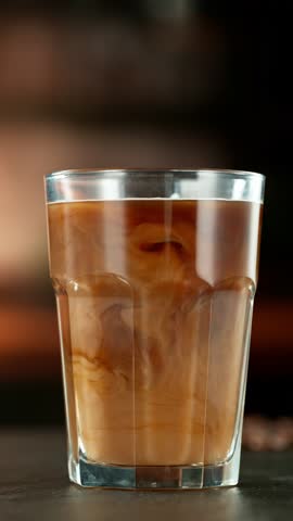 Super Slow Motion Shot of Pouring Milk into Ice Coffee , Camera Move, Filmed on High Speed Cinematic Camera