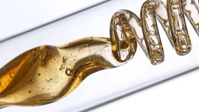 Getting natural oil from natural substances and flowers. Yellow oil flows in a spiral. Super slow motion filmed on high speed cinematic camera. - Powered by Shutterstock - Get 15% off with code: PIKWIZARD15