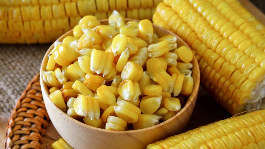 boiled sweet corn on wooden background