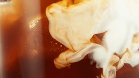Super Slow Motion of Pouring Milk Into Ice Coffee Drink, Close-up. Filmed on High Speed Cinema Camera, 1000 fps. - Powered by Shutterstock - Get 15% off with code: PIKWIZARD15