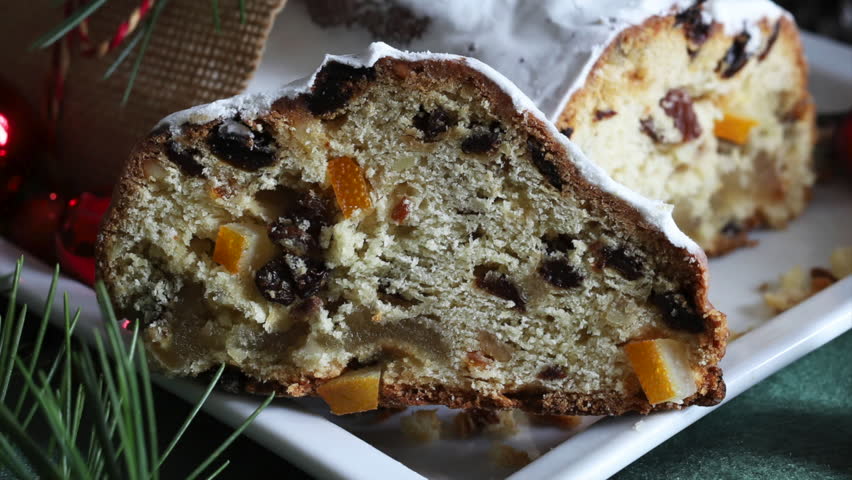 Traditional Christmas german dessert Stollen also know Christstollen cut into pieces. Sweet leavened dough with spices, candied fruit and dried fruit. Holiday season.