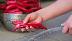 Close up shot of a woman washing hot peppers with a hose. Slow motion. - Powered by Shutterstock - Get 15% off with code: PIKWIZARD15