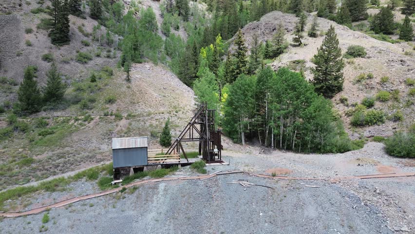 Hard Tack Mine on the Alpine Loop near Lake City, Colorado. Aerial rotating shot that features the head frame on the site.