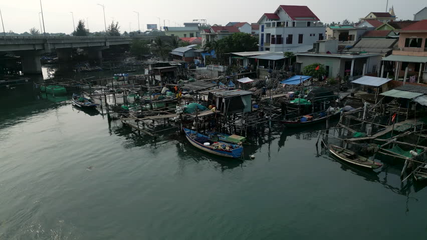 next to the large luxurious houses on the island are the small boats of the fishermen in vietnam