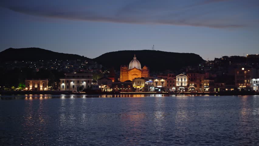 Mytilene city on the Greek island of Lesbos with Greek Orthodox Church Saint Therapon building in view at night, Static shot