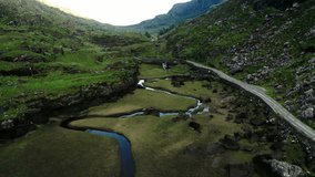 Drone shot of a river meandering through Ireland's Gap of Dunloe. - Powered by Shutterstock - Get 15% off with code: PIKWIZARD15