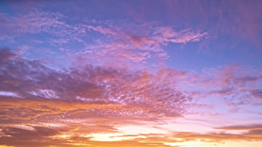 Sunset with sun and clouds on blue and orange dramatic sky with sun rays. Night sunset Sky timelapse. Moving clouds at sunset. Evening Clouds. Dusk twilight sunset sky time lapse. Dramatic sky.