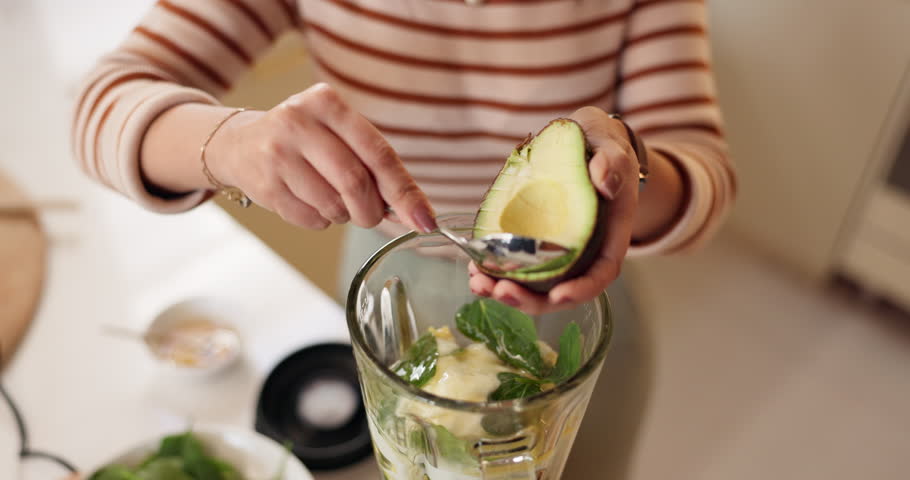 Hands, woman and avocado in blender in kitchen for breakfast drink, healthy diet and top view. Person, nutritionist and prepare ingredients in home for detox shake, nutrition smoothie and meal recipe