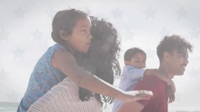 Animation of independence day text and flag of america over caucasian parents piggybacking children. Digital composite, patriotism, freedom, celebration, family, childhood, together, beach, holiday. - Powered by Shutterstock - Get 15% off with code: PIKWIZARD15