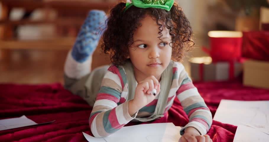 Christmas, kid and thinking in home with paper, drawing and writing note to Santa. Young girl, idea and picture on floor for creativity, gift brainstorming and DIY greeting card for festive season