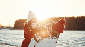 Happy young couple dating at winter sunny day outside at Christmas holidays. Family weekend spend time together. Christmas eve and love between two people. Girl and a guy have fun and laugh at sunset - Powered by Shutterstock - Get 15% off with code: PIKWIZARD15
