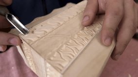 Craftsman work on his beautiful wood ornamental box. Closeup shot of master craftsman doing traditional wood carving. Woodworking, craftsmanship and handwork concept. Carpenter wood carving equipment. - Powered by Shutterstock - Get 15% off with code: PIKWIZARD15