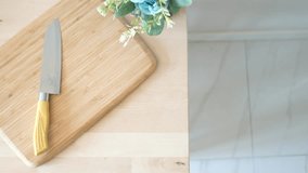 Essential Kitchen Tools A Knife Resting on a Bamboo Cutting Board Next to a Decorative Plant - Powered by Shutterstock - Get 15% off with code: PIKWIZARD15