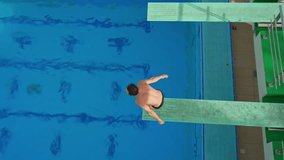 A professional athlete executes a flawless spring dive during a competition. The athlete's precision, strength, and grace are on full display, capturing the intensity and beauty of competitive diving. - Powered by Shutterstock - Get 15% off with code: PIKWIZARD15