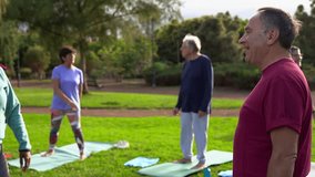 Group of senior people talking together after yoga class at city park - Fit healthy elderly community and sport concept  - Powered by Shutterstock - Get 15% off with code: PIKWIZARD15